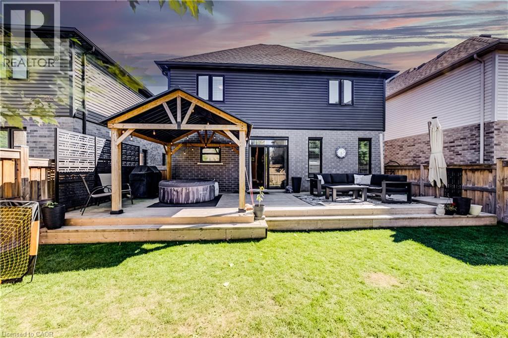Expansive backyard featuring a tiered deck, built-in gazebo, and manicured lawn - 35 Greyhawk Street, Kitchener, ON