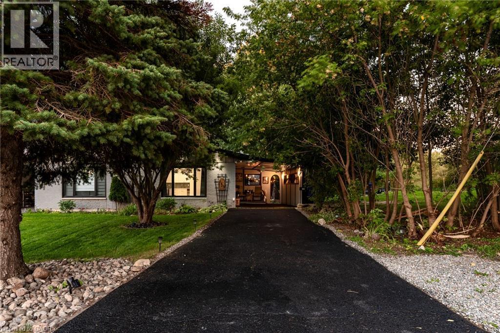 Front at dusk, tree-lined drive, parking for six - 139 Town Line, Orangeville, ON