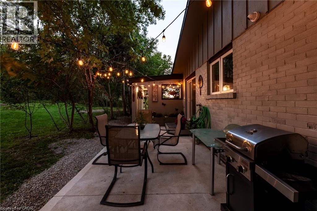 Patio and BBQ area at dusk - 139 Town Line, Orangeville, ON