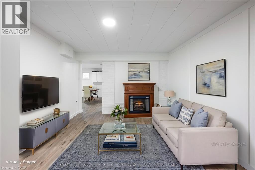 Lower-level living room with fireplace – virtually staged - 139 Town Line, Orangeville, ON