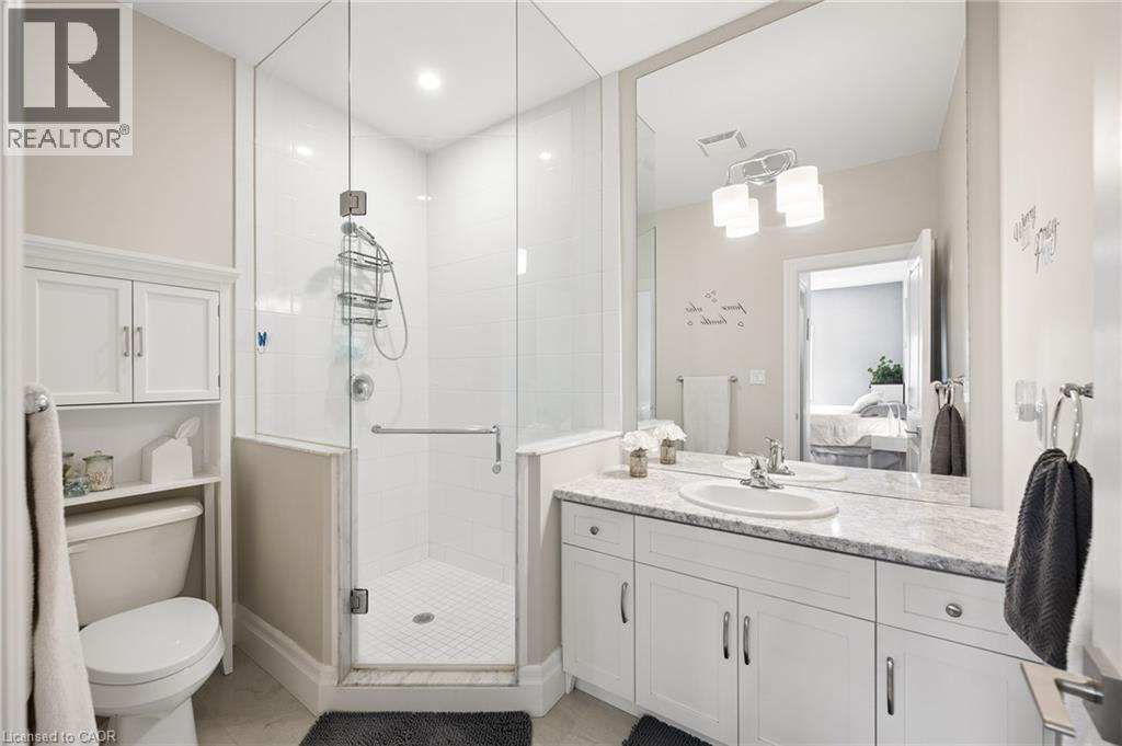 Spacious vanity with dual sinks, a large mirror, and ample under-sink storage - 192 Brewery Street Unit# 18, Baden, ON