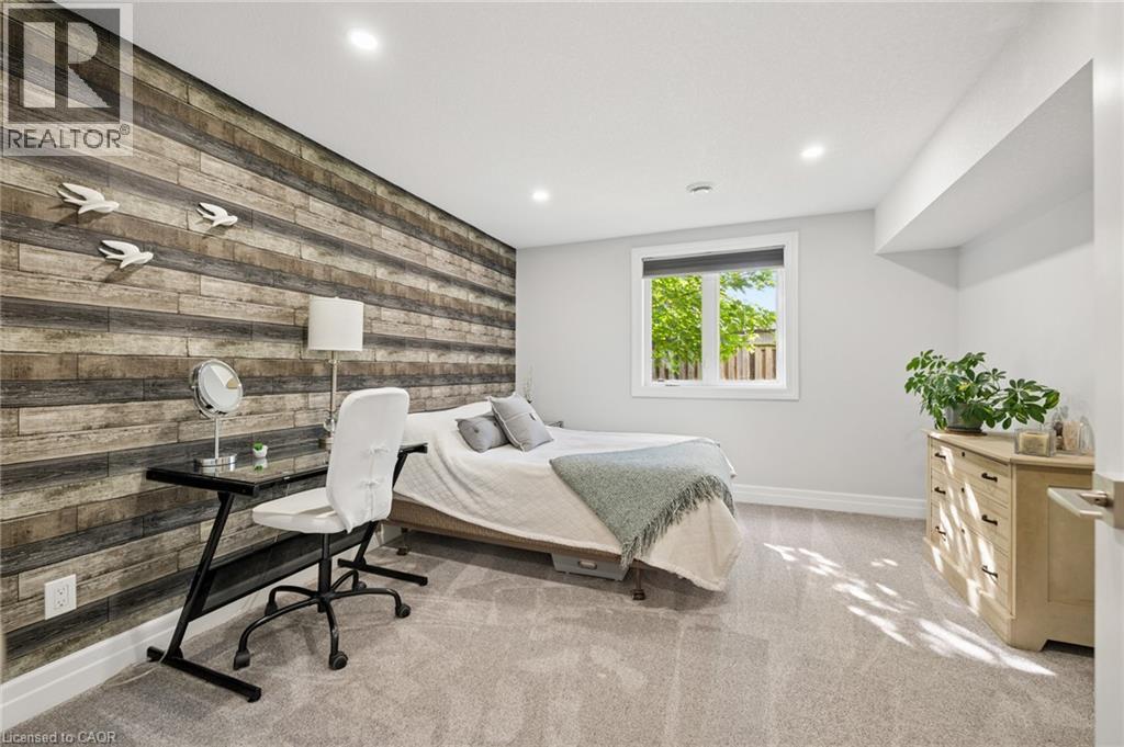 Recessed lighting, wood-finish accent wall, light-colored carpeting, white trim, and a window with a roller blind - 192 Brewery Street Unit# 18, Baden, ON