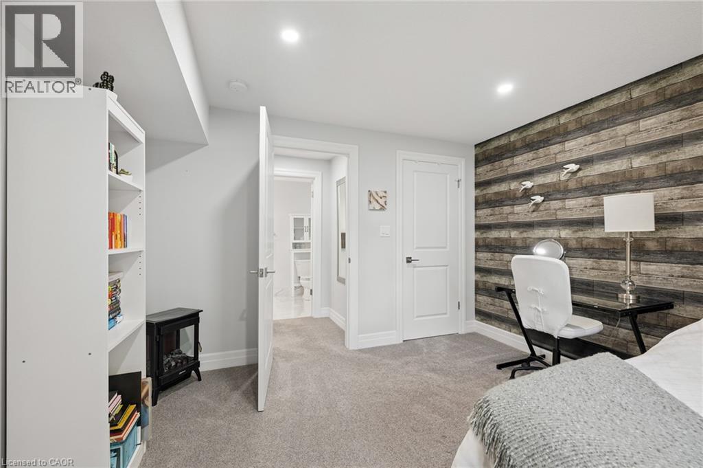 Recessed lighting, wood-finish accent wall, light gray carpeting, and white interior doors - 192 Brewery Street Unit# 18, Baden, ON