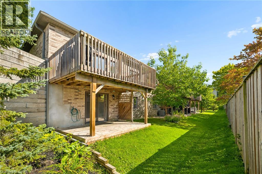Elevated wood deck with railing, ground-level wood patio, brick exterior, - 192 Brewery Street Unit# 18, Baden, ON