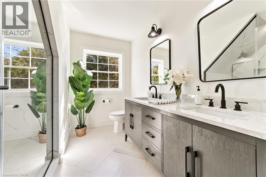 Double vanity with undermount sinks, matte black fixtures, and light-toned countertops - 5367 2 Side Road, Milton, ON