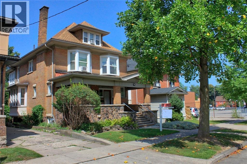 Brick exterior with bay windows and a dormer - 22 Blake Street, Hamilton, ON - Outdoor With Facade