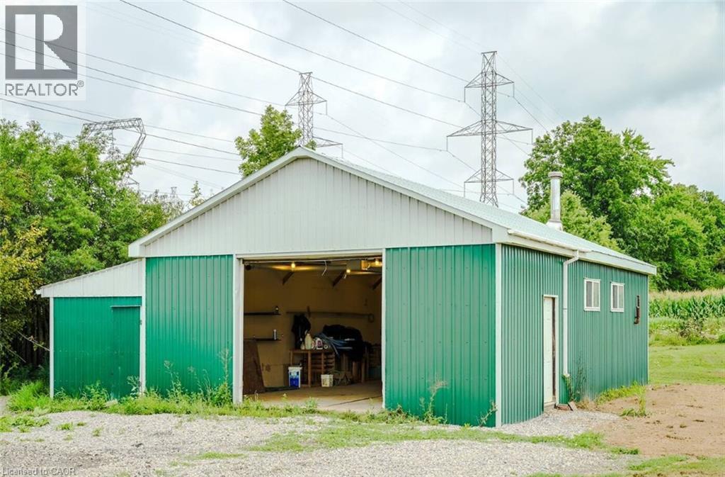 Steel-sided outbuilding with a gable roof and roll-up door - 107 6Th Line Line, Haldimand, ON - Outdoor