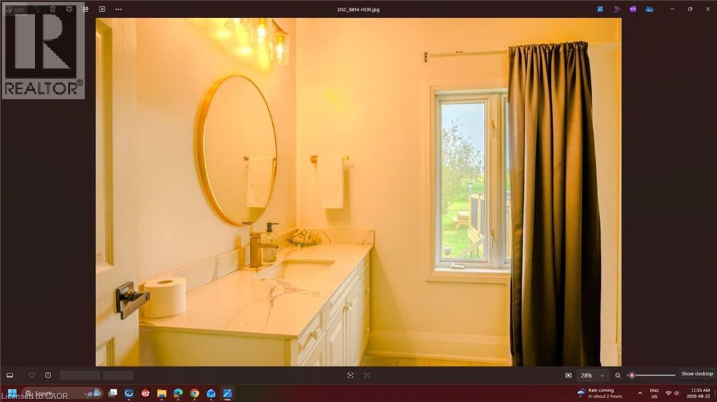 White vanity with integrated sink, stone-finish countertop, and wall-mounted lighting - 107 6Th Line Line, Haldimand, ON - Indoor Photo Showing Bathroom