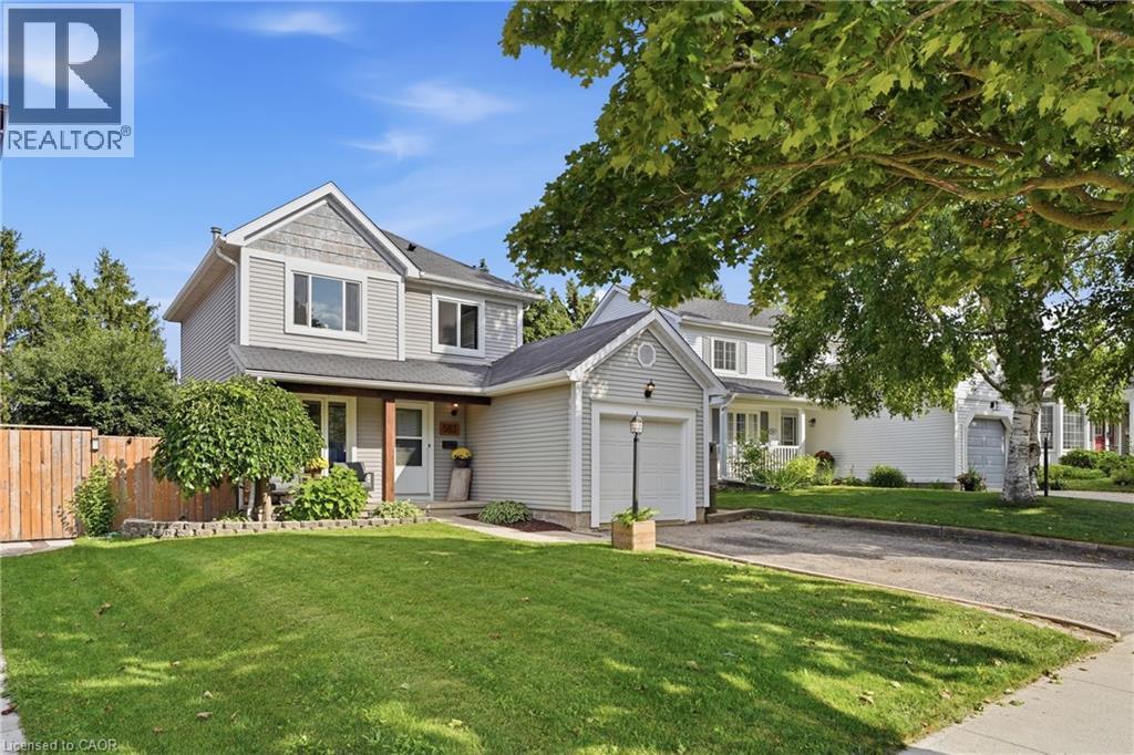 Two-story residence featuring light gray siding with shingle accents and white trim - 563 Westvale Drive, Waterloo, ON - Outdoor With Facade