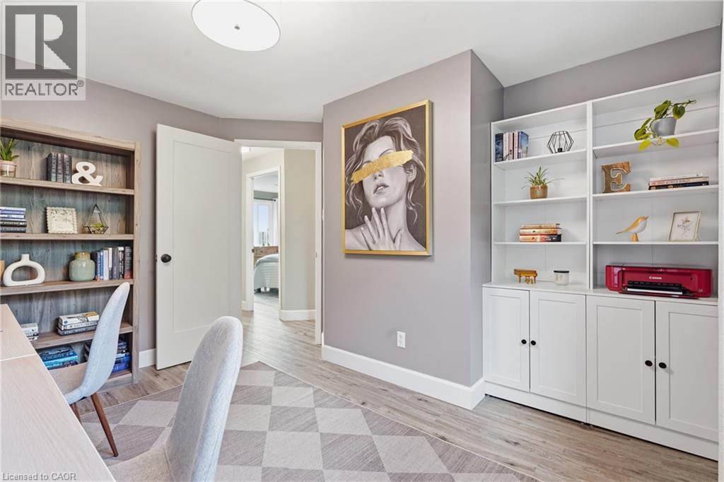 Wood-finish flooring with a textured area rug - 563 Westvale Drive, Waterloo, ON - Indoor Photo Showing Other Room