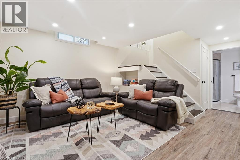 Recessed lighting, wood-finish flooring, built-in shelving, white trim, and a white door leading to a bathroom with a shower - 563 Westvale Drive, Waterloo, ON - Indoor