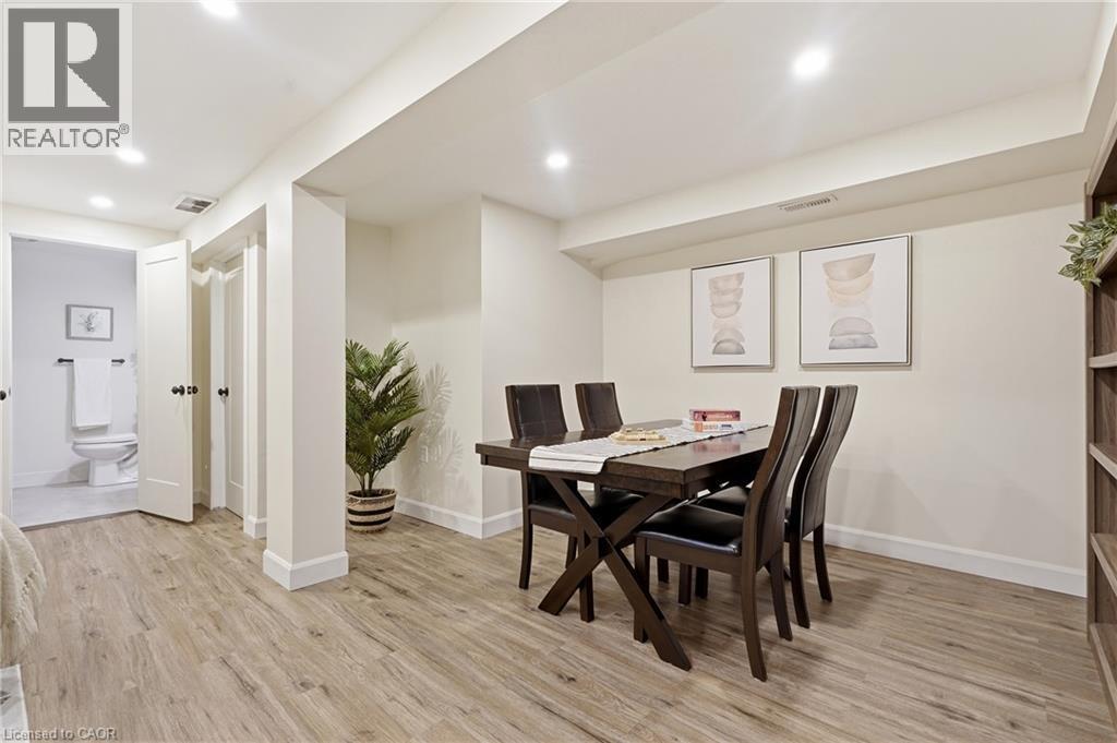 Recessed lighting, wood-finish flooring, white trim, and a built-in shelving unit - 563 Westvale Drive, Waterloo, ON - Indoor Photo Showing Dining Room