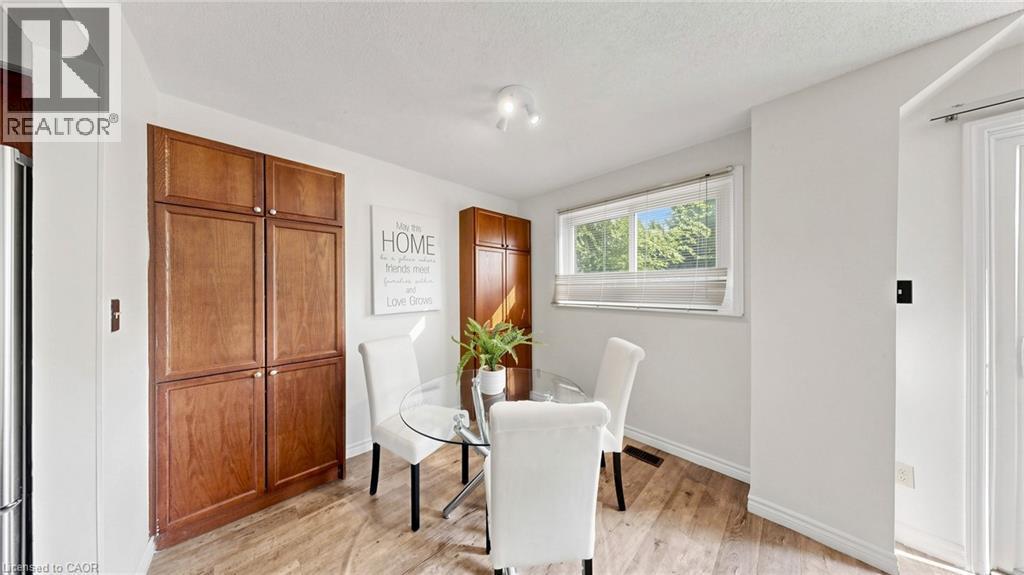 Hardwood-style flooring with built-in cabinetry and a window offering natural illumination - 304 Bluevale Street N, Waterloo, ON - Indoor Photo Showing Dining Room