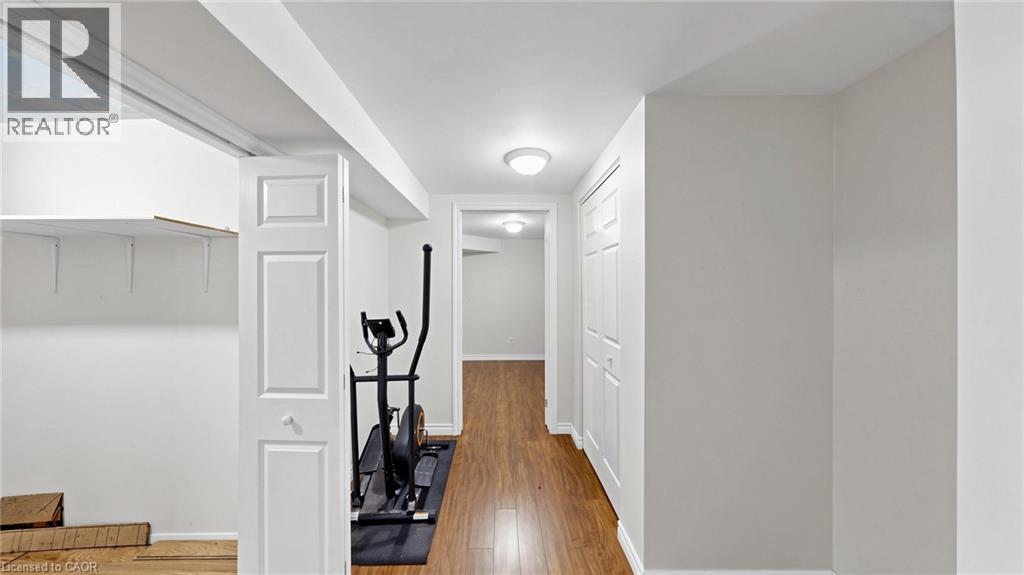 Recessed storage area with shelving, paneled interior doors, and wood-finish flooring - 304 Bluevale Street N, Waterloo, ON - Indoor Photo Showing Other Room
