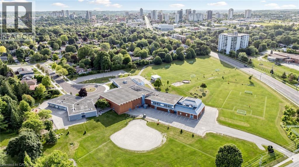 Expansive property with a large building structure, surrounding green spaces, and paved parking areas - 304 Bluevale Street N, Waterloo, ON - Outdoor With View