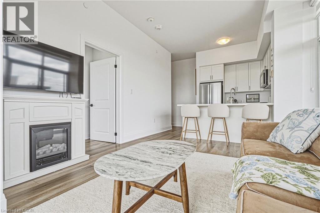 470 E Dundas Street E Unit# 1202, Waterdown, ON - Indoor Photo Showing Living Room With Fireplace