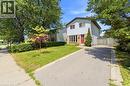 Split-level residence featuring light-colored siding and a contrasting red entry door - 23 Heatherdale Place, Hamilton, ON  - Outdoor 
