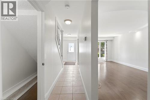 Foyer featuring tiled flooring and direct access to a staircase with white railings - 23 Heatherdale Place, Hamilton, ON - Indoor Photo Showing Other Room