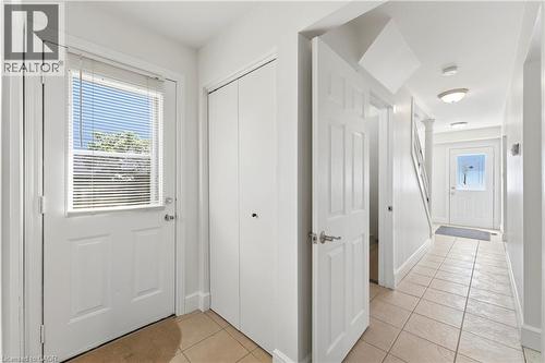 Entryway featuring a white door with an integrated window, a built-in closet, and light-toned tile flooring - 23 Heatherdale Place, Hamilton, ON - Indoor Photo Showing Other Room