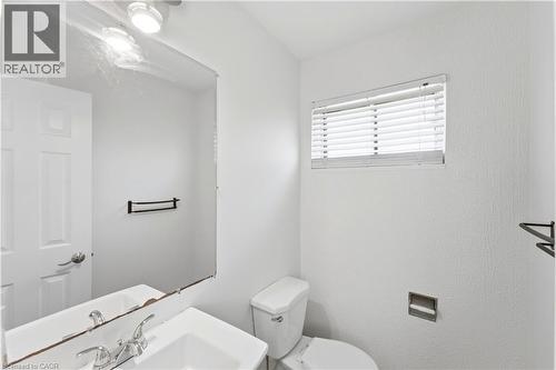 Integrated vanity with a single basin sink and chrome faucet - 23 Heatherdale Place, Hamilton, ON - Indoor Photo Showing Bathroom