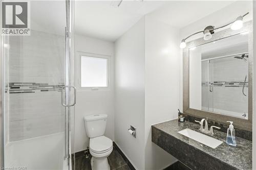 Frameless glass shower enclosure with tile accent band - 23 Heatherdale Place, Hamilton, ON - Indoor Photo Showing Bathroom