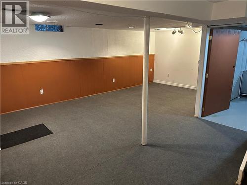 Carpeted flooring, brown wainscoting, white walls, and track lighting - 23 Heatherdale Place, Hamilton, ON - Indoor
