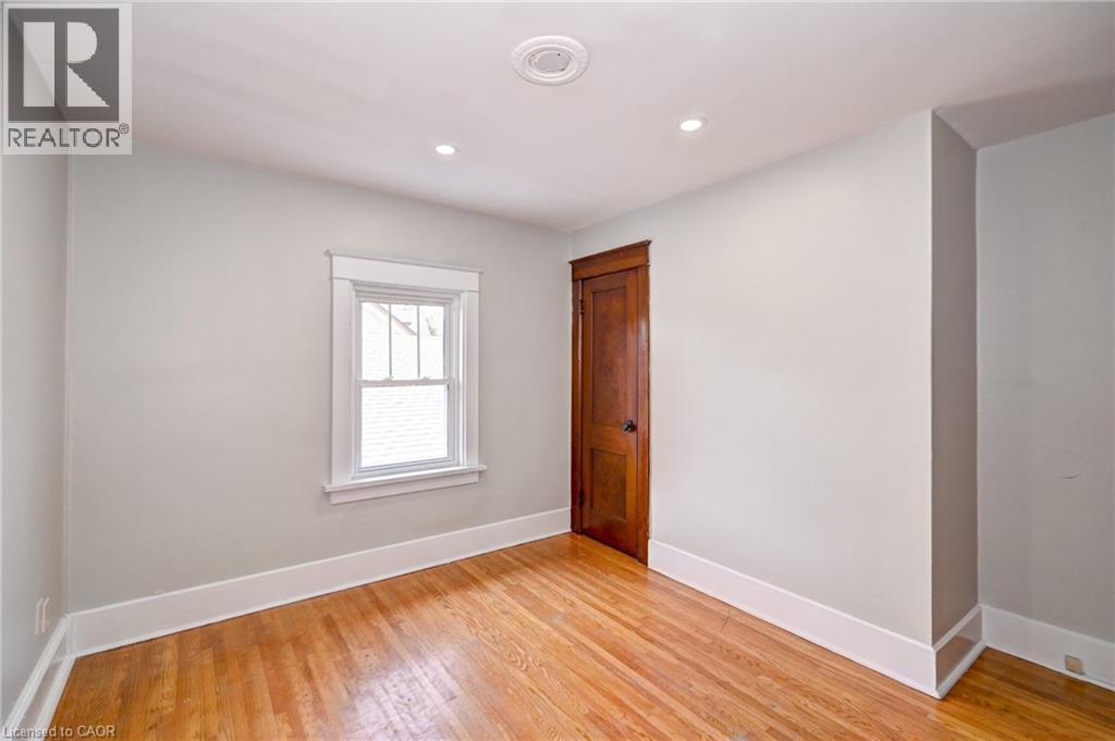 Hardwood flooring with white baseboards and window trim - 147 Courtland Avenue E, Kitchener, ON - Indoor Photo Showing Other Room