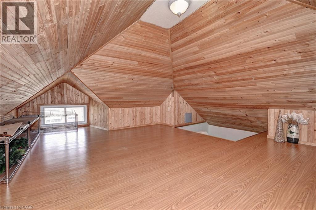 Expansive loft area featuring wood-finish flooring, wood plank walls, and a vaulted wood plank ceiling - 147 Courtland Avenue E, Kitchener, ON - Indoor Photo Showing Other Room