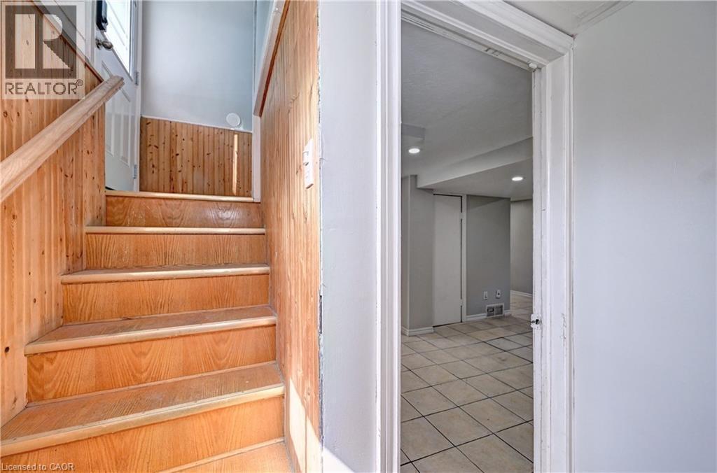 Wood-panel staircase with matching handrail - 147 Courtland Avenue E, Kitchener, ON - Indoor Photo Showing Other Room