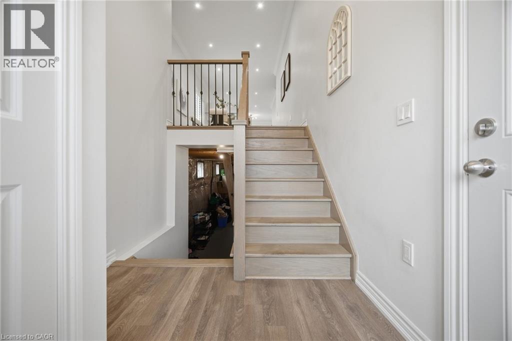 Wood-finish flooring leading to a staircase with wood treads - 20 Todd Crescent, Dundalk, ON - Indoor Photo Showing Other Room