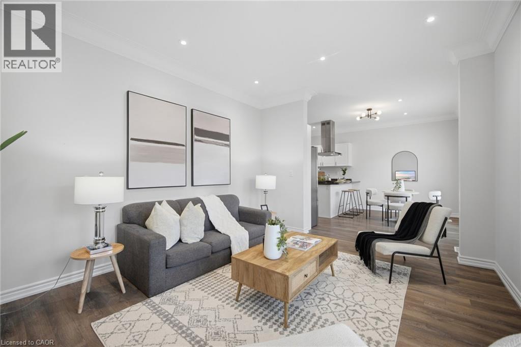 Recessed ceiling lighting, crown molding, wood-finish flooring, and white interior walls - 20 Todd Crescent, Dundalk, ON - Indoor Photo Showing Living Room