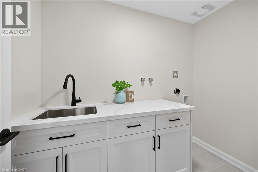 Convenient 2nd floor laundry room features modern cabinetry and quartz counter top. - 45B Howard Street, Hagersville, ON