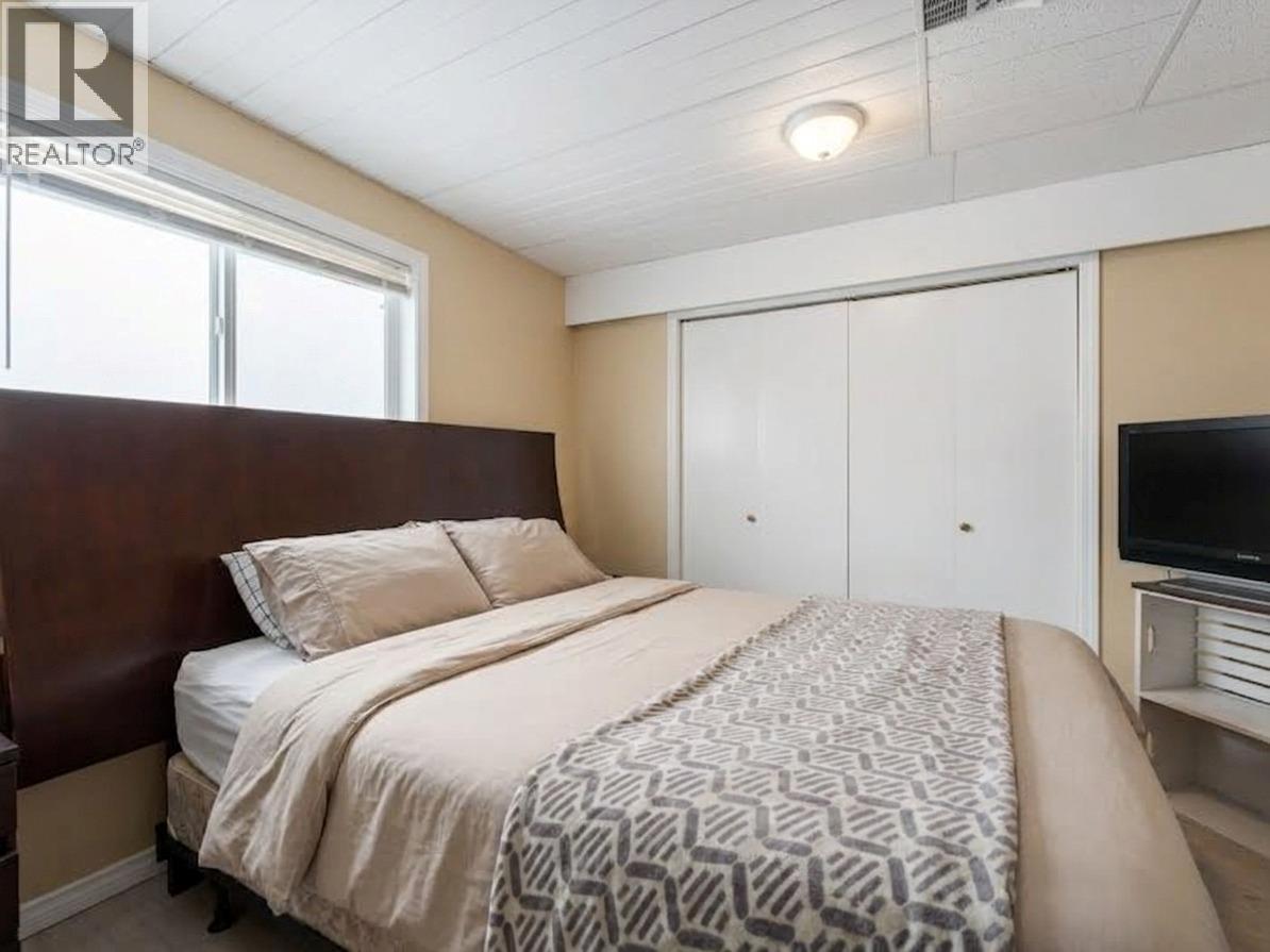 Suite Bedroom 1, virtually staged. - 3368 Mciver Road, West Kelowna, BC