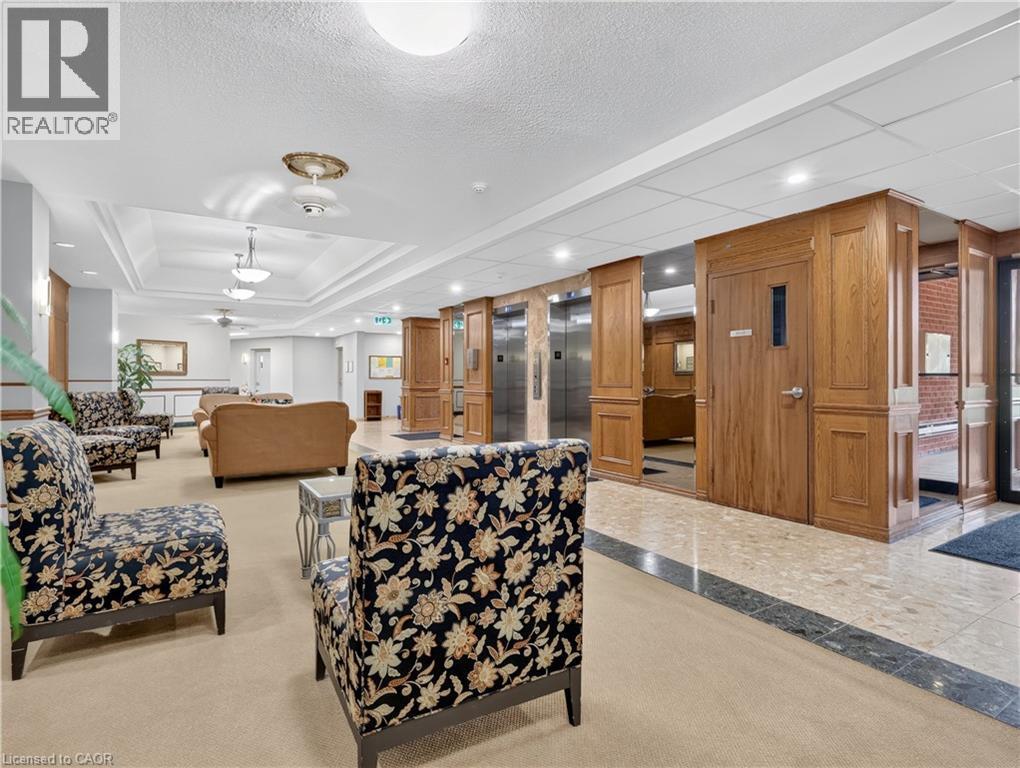 Carpeted flooring, recessed lighting, drop ceiling, elevator access, and wood paneling - 7 Gale Crescent Unit# 1107, St. Catharines, ON