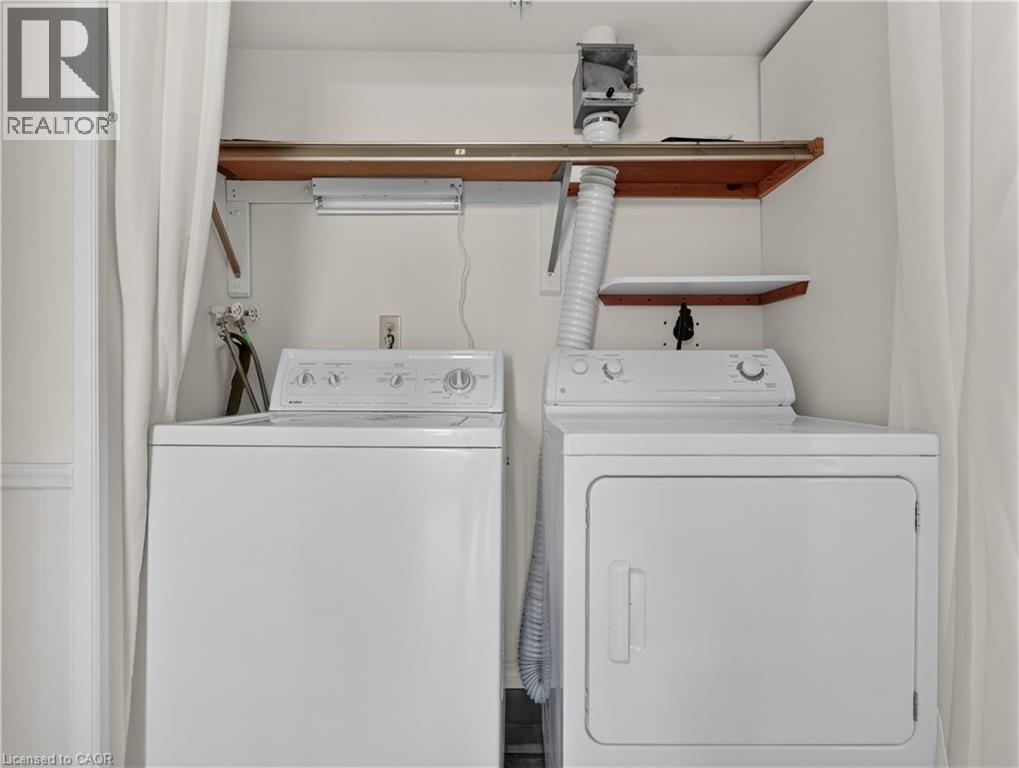 Dedicated laundry area featuring a white top-load washing machine and a white front-load dryer - 7 Gale Crescent Unit# 1107, St. Catharines, ON