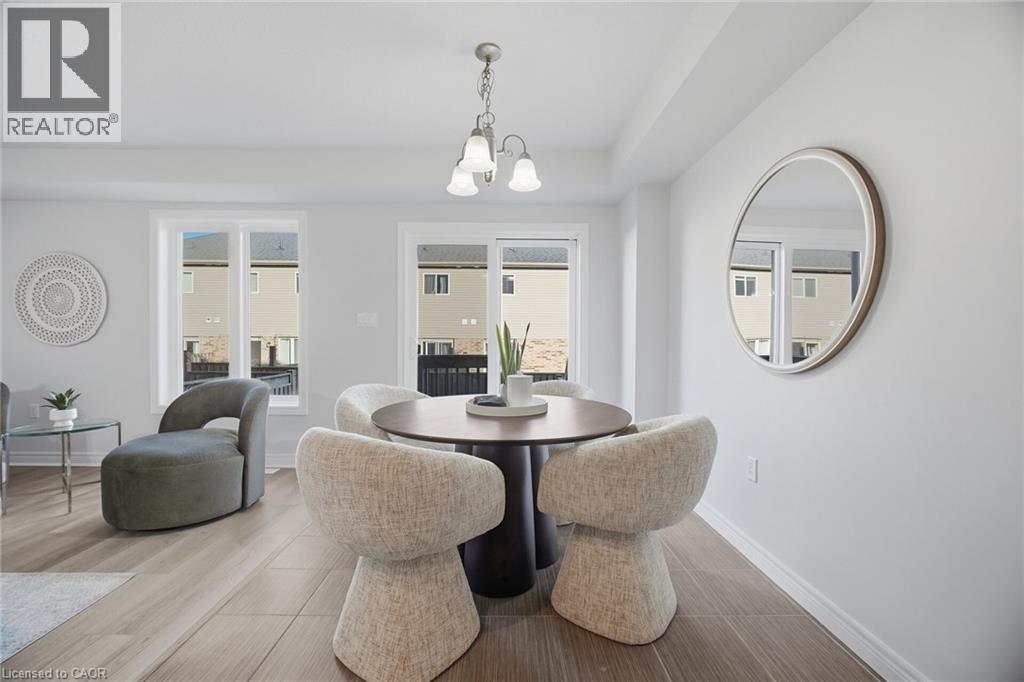 Recessed lighting, wood-finish flooring, white walls, multiple windows, and a sliding glass door - 98 Bloom Crescent, Stoney Creek, ON
