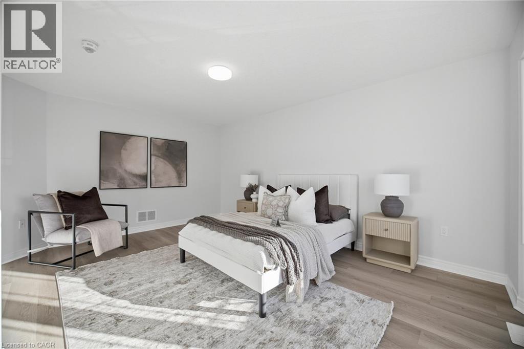Wood-finish flooring with white baseboards, recessed ceiling lighting, and a window providing natural illumination - 98 Bloom Crescent, Stoney Creek, ON