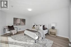 Wood-finish flooring with white baseboards, recessed ceiling lighting, and a window providing natural illumination -