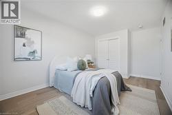 Recessed lighting, wood-finish flooring, and white walls -