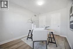Recessed lighting, wood-finish flooring, white trim, and white paneled doors -