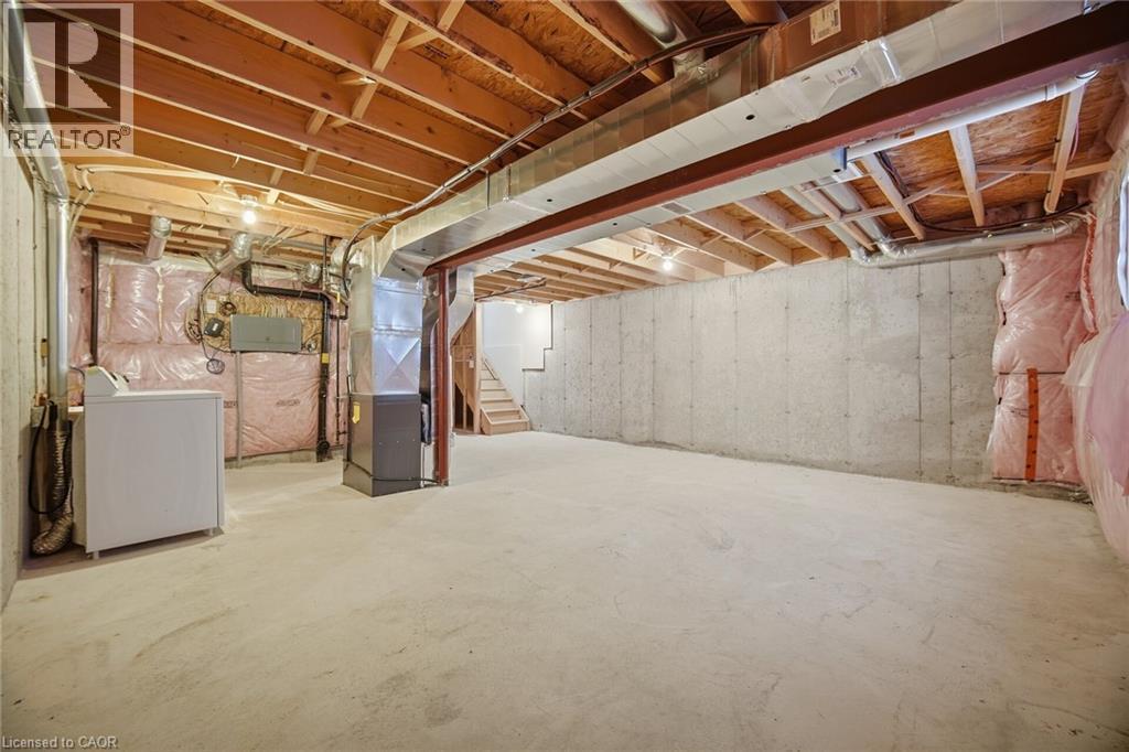 Unfinished basement featuring exposed wood joists, concrete flooring, and concrete walls - 98 Bloom Crescent, Stoney Creek, ON