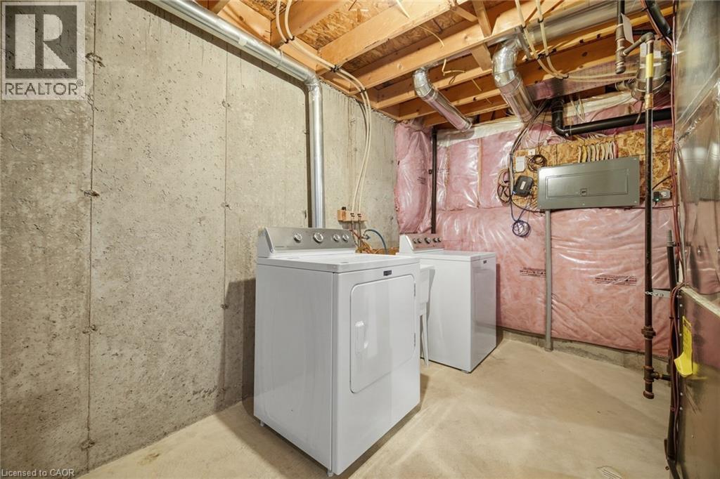 Unfinished basement space with exposed concrete walls, exposed ceiling joists, and visible insulation - 98 Bloom Crescent, Stoney Creek, ON