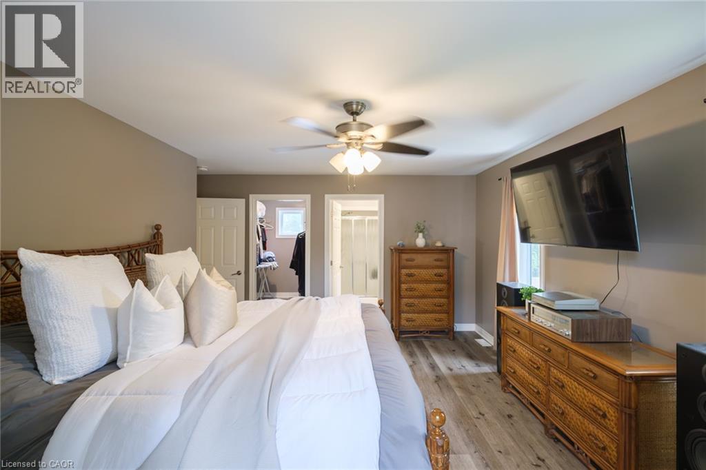 Wood-finish flooring throughout, ceiling fan with integrated lighting, and neutral wall tones - 78 Oak Street, Simcoe, ON