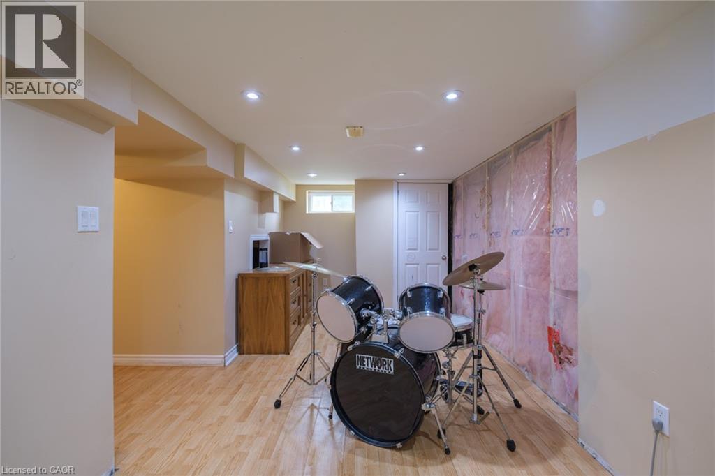Wood-finish flooring with recessed lighting, an interior door, and a horizontal window - 78 Oak Street, Simcoe, ON