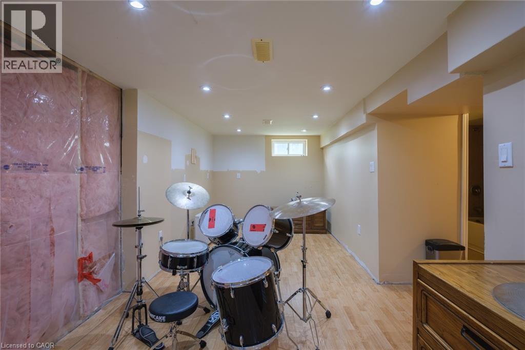 Recessed lighting throughout, wood-finish flooring, and exposed insulation - 78 Oak Street, Simcoe, ON