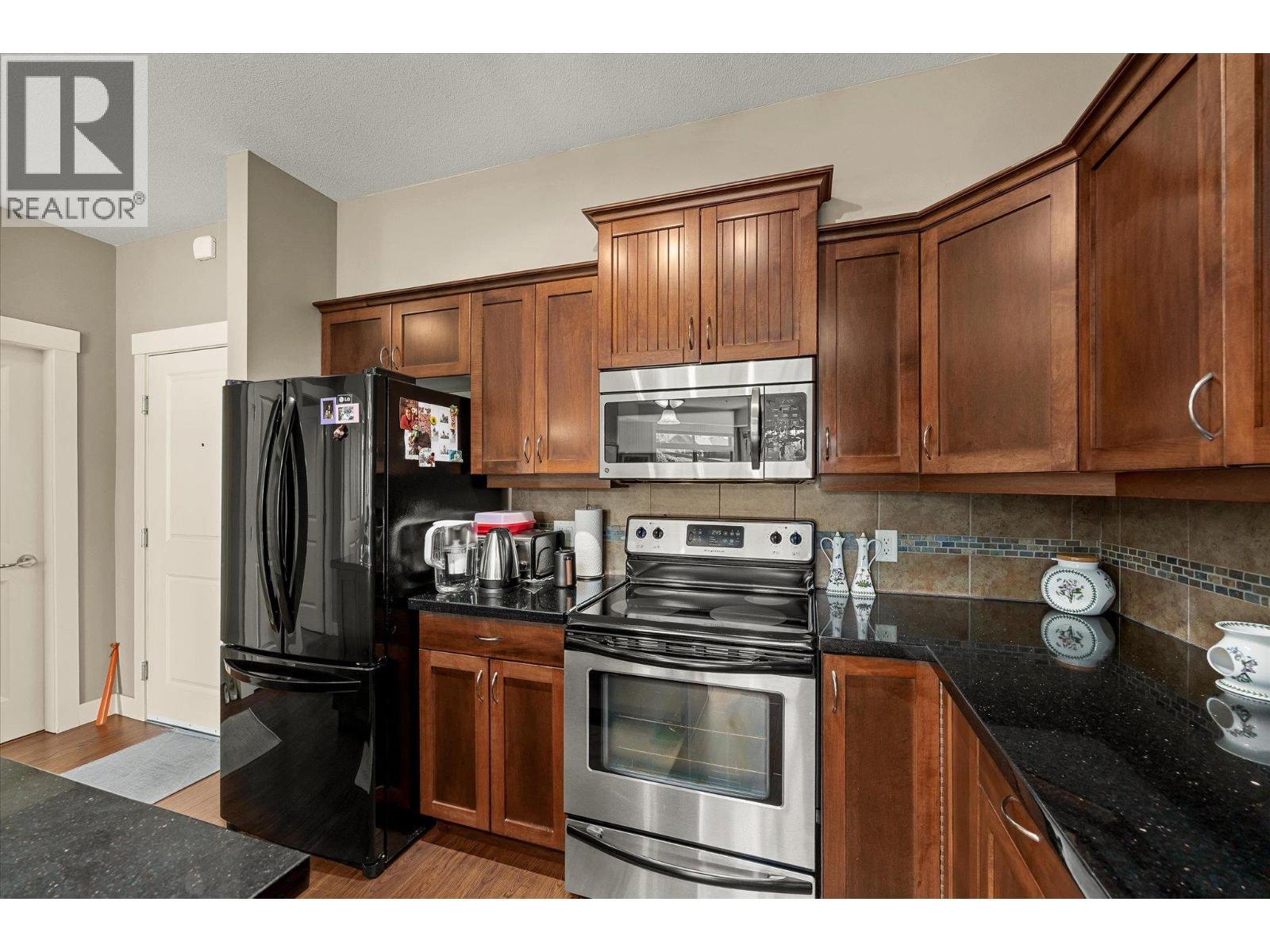 Beautiful kitchen with black granite counters. - 3545 Carrington Road Unit# 108, West Kelowna, BC