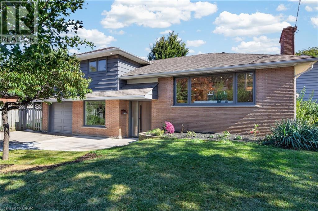 Brick and siding exterior with a shingled roof - 3028 Eva Drive, Burlington, ON