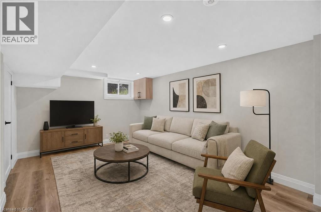 Recessed ceiling lighting, wood-finish flooring, light-toned wall finishes, and a single pane window - 3028 Eva Drive, Burlington, ON