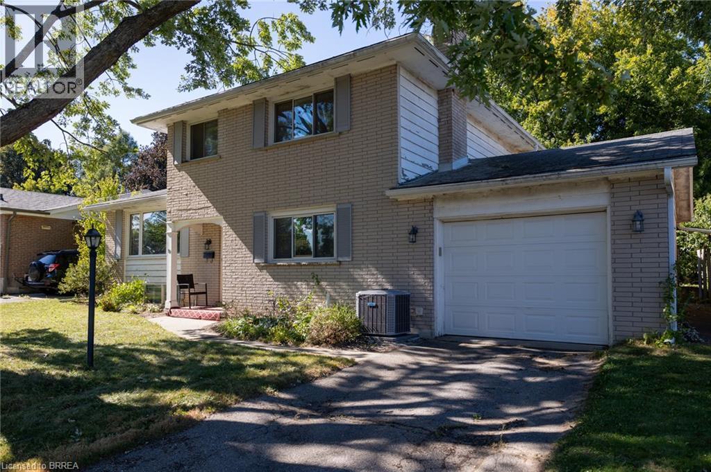 Brick exterior with white siding accents and a single-car garage - 52 Brier Park Road, Brantford, ON