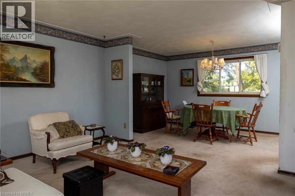 Expansive living space with light blue walls and decorative wallpaper border - 52 Brier Park Road, Brantford, ON
